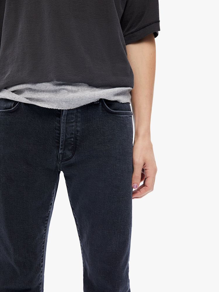 Front close up view of a mens black jean featuring a straight leg and clean hem.