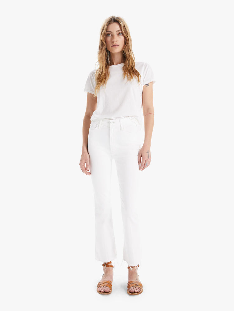 Front view of a womens white wash jean featuring a high rise, flare leg, and a frayed hem.