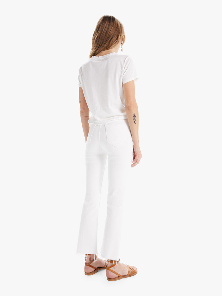 Back view of a womens white wash jean featuring a high rise, flare leg, and a frayed hem.