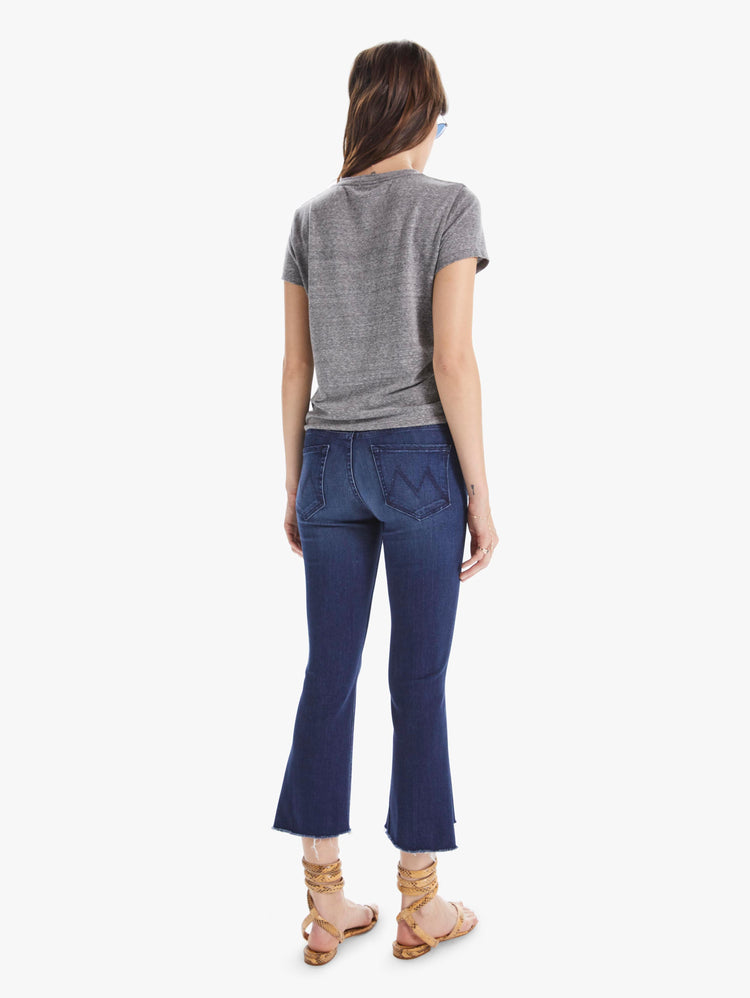 Back view of women’s dark blue cropped bootcut with step frayed hem