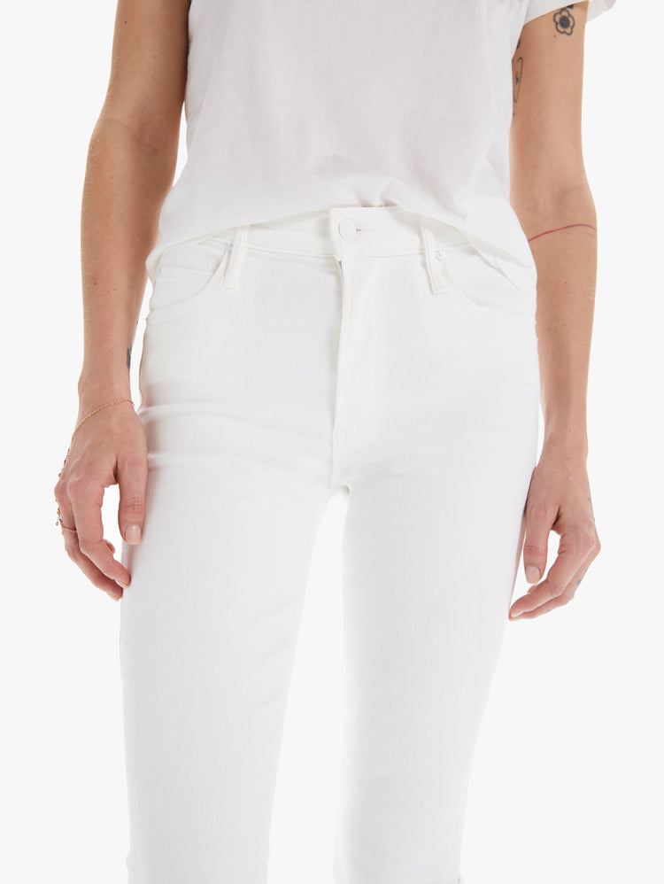 detail view of women's white mid rise straight leg jean with ankle inseam, zip fly, and clean hem