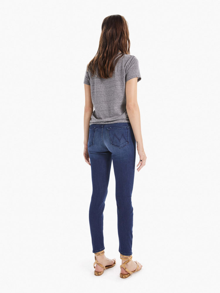 Back view of women's dark blue mid rise skinny with zip fly and clean hem