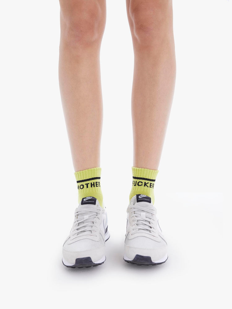 Front view of women's light green ankle sock featuring "Mother Fucker" in black
