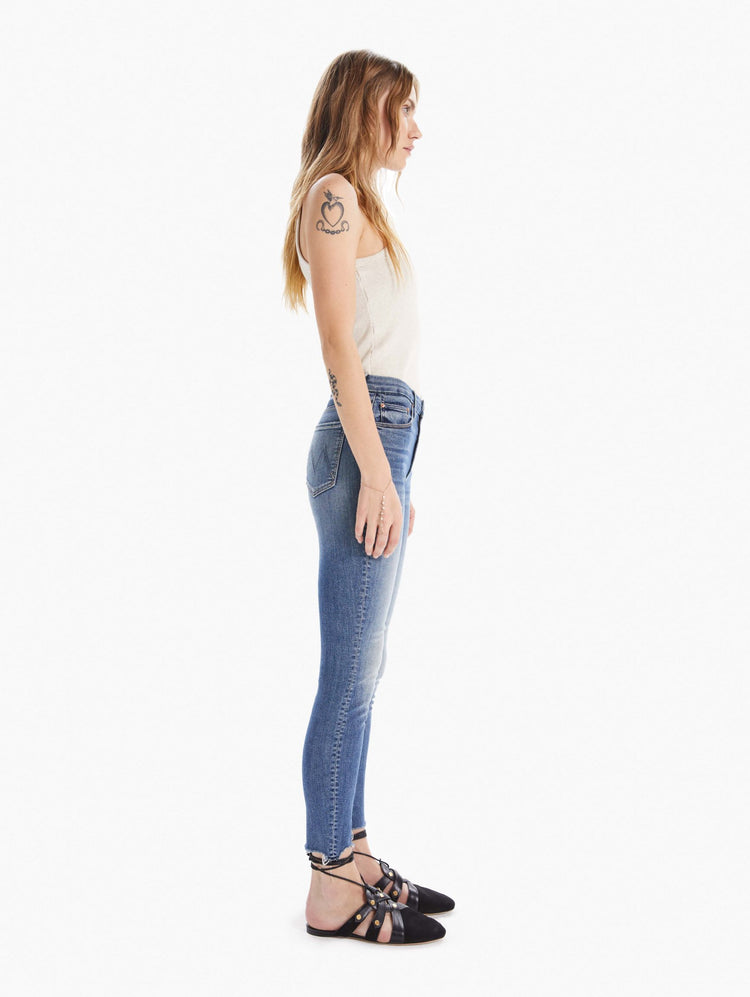 side view women's high waisted skinny denim with zipper fly and fray ankle hem