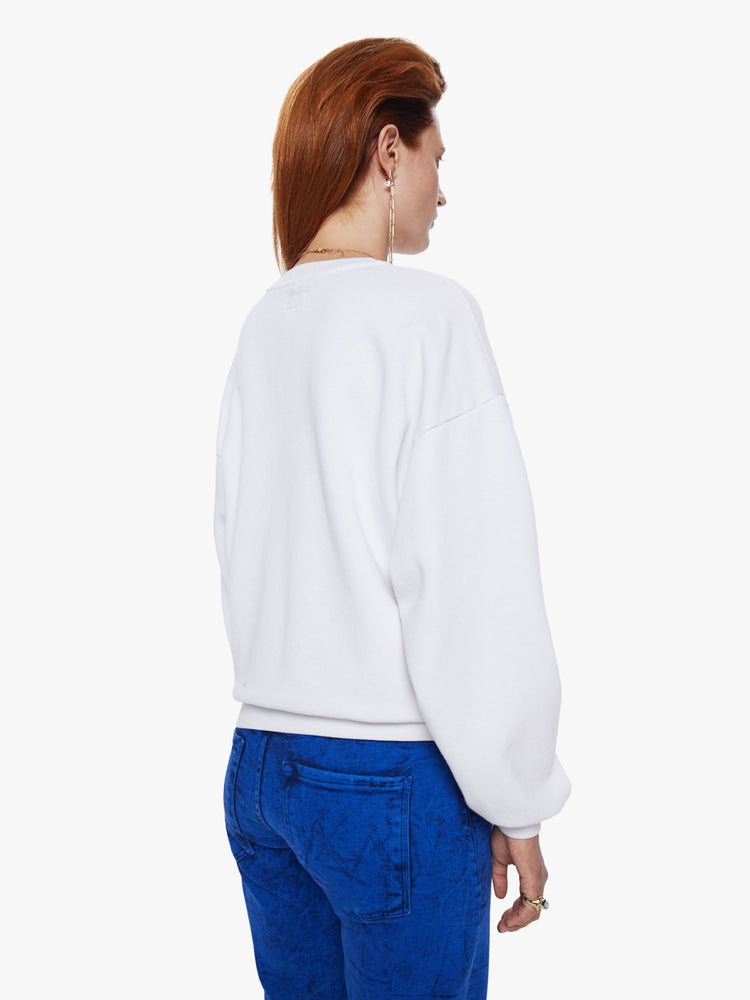 Back view of a woman in a crewneck sweatshirt from Mothers David Bowie capsule collection the 100% cotton sweatshirts is designed with dropped sleeves and a relaxed fit and features a blue and red text graphic on the front
