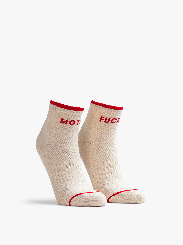 Front view of ghost image of a pair of grey socks with a red stripe along the ankle, one reading "MOTHER" the other reading "FUCKER"